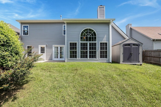 2117 Spring Hill Cir, Spring Hill, TN 37174 - back of property with french doors, a shed, and a chimney