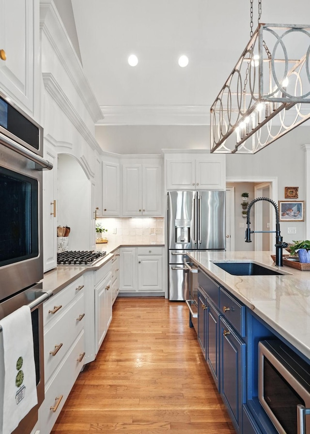 529 Derby Downs, Lebanon, TN 37087 - kitchen with blue cabinetry, stainless steel appliances, white cabinetry, ornamental molding, and recessed lighting