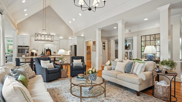 529 Derby Downs, Lebanon, TN 37087 - living room with ornate columns, light wood-style flooring, recessed lighting, a chandelier, and high vaulted ceiling
