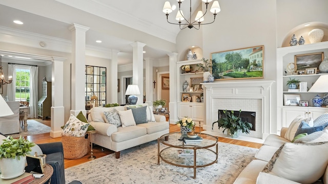 529 Derby Downs, Lebanon, TN 37087 - living room featuring a chandelier, decorative columns, wood finished floors, ornamental molding, and built in features