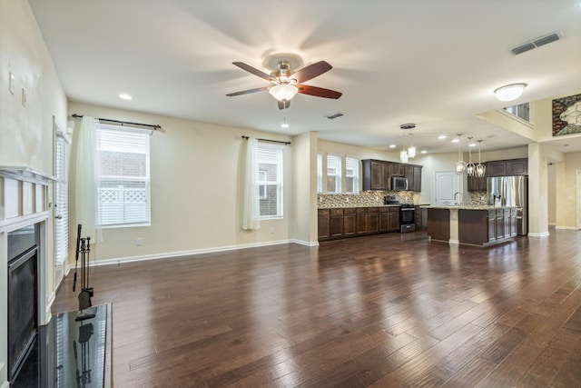 654 Foster Ln, Mount Juliet, TN 37122 - living area featuring a glass covered fireplace, a ceiling fan, plenty of natural light, dark wood-type flooring, and recessed lighting