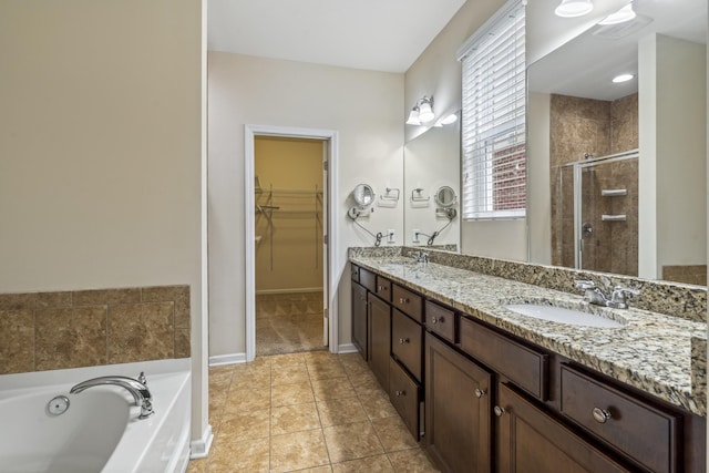 654 Foster Ln, Mount Juliet, TN 37122 - bathroom with a shower stall, double vanity, a bath, a spacious closet, and tile patterned floors