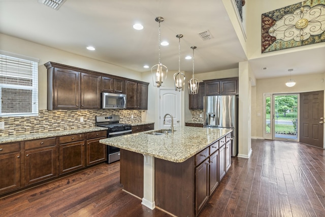654 Foster Ln, Mount Juliet, TN 37122 - kitchen with stainless steel appliances, dark brown cabinets, dark wood-style floors, light stone countertops, and decorative backsplash