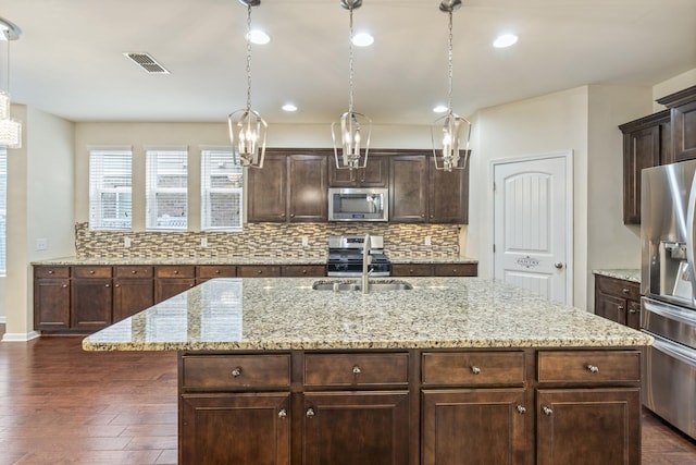 654 Foster Ln, Mount Juliet, TN 37122 - kitchen featuring stainless steel appliances, backsplash, a kitchen island with sink, dark wood-type flooring, and dark brown cabinetry