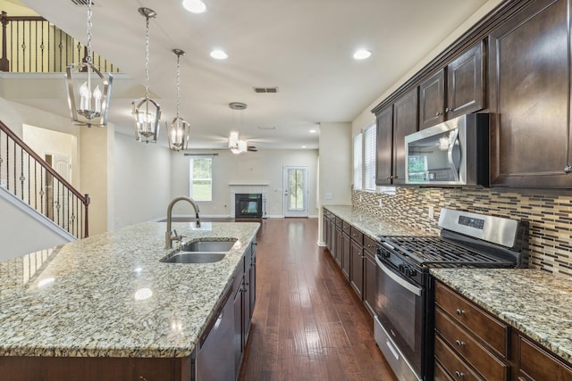 654 Foster Ln, Mount Juliet, TN 37122 - kitchen with appliances with stainless steel finishes, a ceiling fan, dark wood finished floors, a glass covered fireplace, and open floor plan