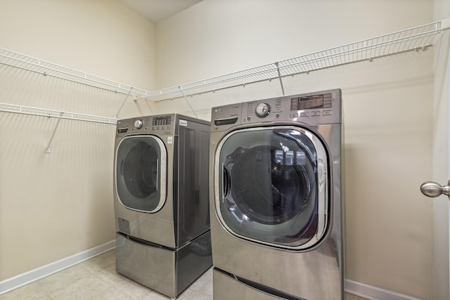 654 Foster Ln, Mount Juliet, TN 37122 - laundry area with washing machine and clothes dryer and light tile patterned flooring