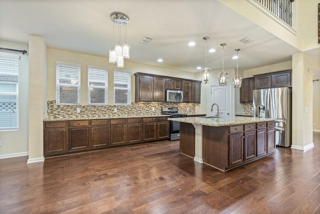654 Foster Ln, Mount Juliet, TN 37122 - kitchen with appliances with stainless steel finishes, a chandelier, dark wood-style flooring, dark brown cabinetry, and backsplash