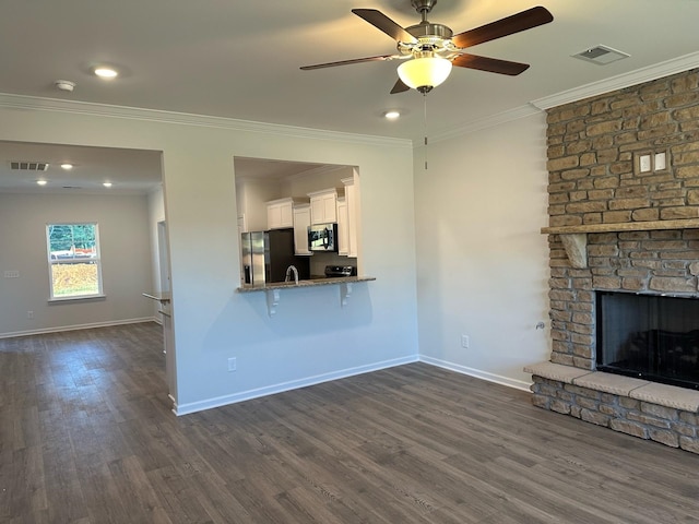 9013 Ada Way, Fairview, TN 37062 - unfurnished living room featuring crown molding, dark wood finished floors, a fireplace, ceiling fan, and recessed lighting