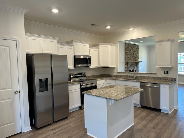 9013 Ada Way, Fairview, TN 37062 - kitchen with stainless steel appliances, dark wood-style flooring, white cabinets, crown molding, and a kitchen island