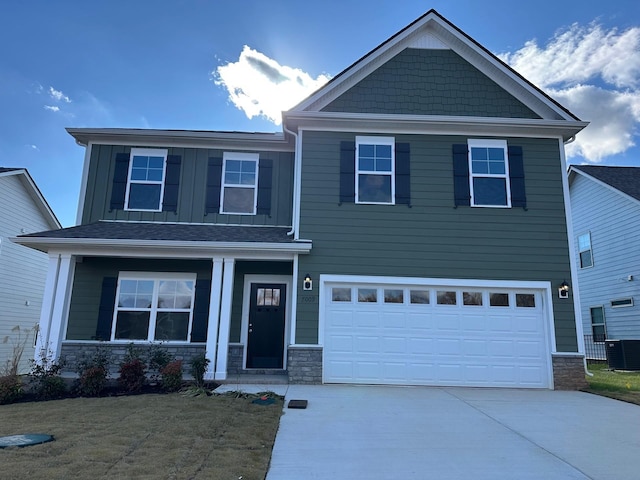 9021 Ada Way, Fairview, TN 37062 - craftsman-style home with driveway, stone siding, an attached garage, and a front lawn