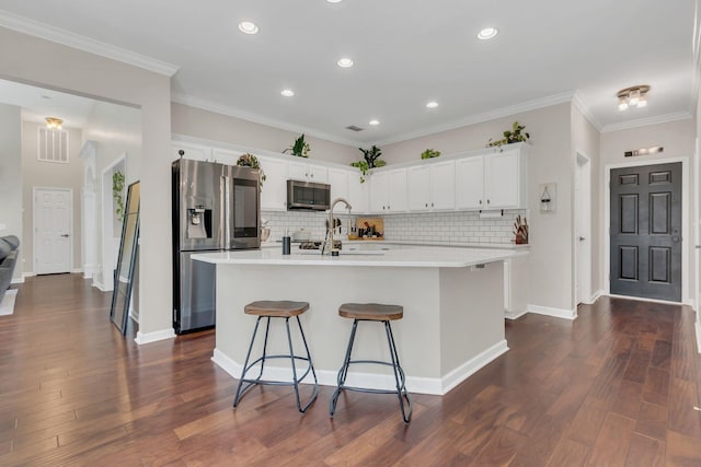 1016 Nealcrest Cir, Spring Hill, TN 37174 - kitchen featuring appliances with stainless steel finishes, backsplash, light countertops, white cabinets, and a kitchen breakfast bar