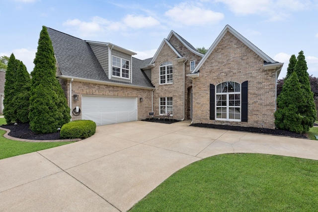 1016 Nealcrest Cir, Spring Hill, TN 37174 - view of front of house with concrete driveway, brick siding, a front lawn, and roof with shingles
