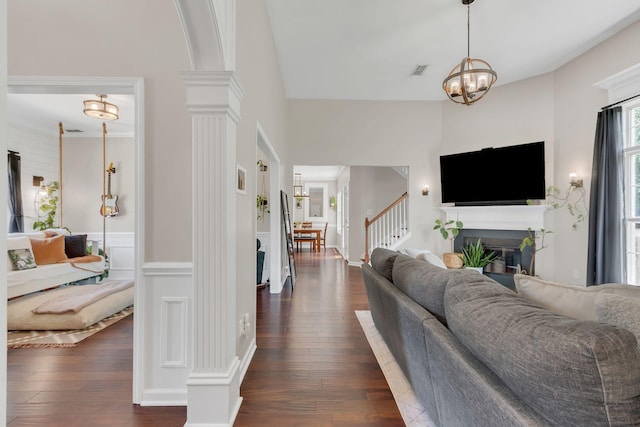 1016 Nealcrest Cir, Spring Hill, TN 37174 - living area featuring dark wood finished floors, a chandelier, ornate columns, and a fireplace