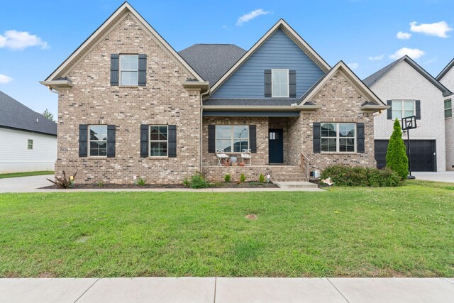 2428 Sandstone Cir, Murfreesboro, TN 37130 - view of front of home featuring brick siding, a front yard, a garage, driveway, and a porch