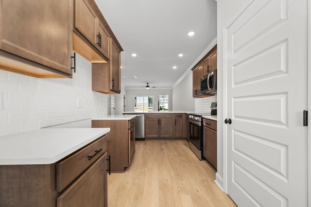 522 Rohan Dr, Murfreesboro, TN 37129 - kitchen featuring stainless steel appliances, decorative backsplash, a peninsula, light wood-type flooring, and recessed lighting
