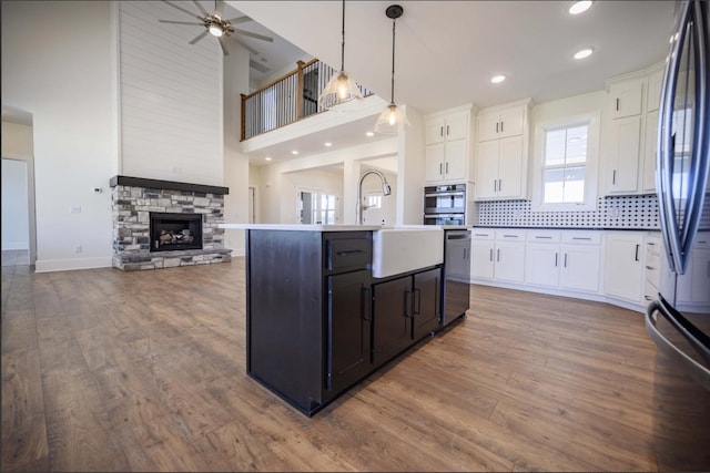150 Bryson Ln, Castalian Springs, TN 37031 - kitchen with open floor plan, appliances with stainless steel finishes, ceiling fan, white cabinets, and an island with sink