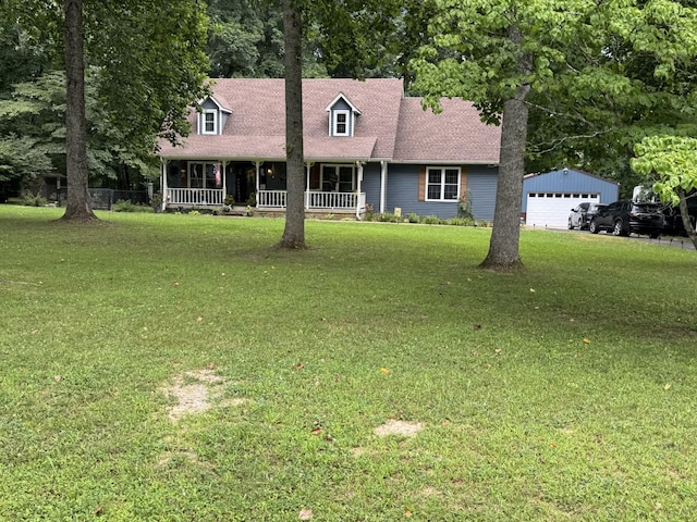 625 Mag A Mor Dr, Lafayette, TN 37083 - cape cod-style house featuring covered porch, a front yard, a garage, and an outbuilding
