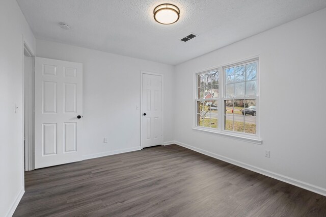 1300 Cadogan Way, Antioch, TN 37013 - unfurnished bedroom with dark wood-style floors and a textured ceiling