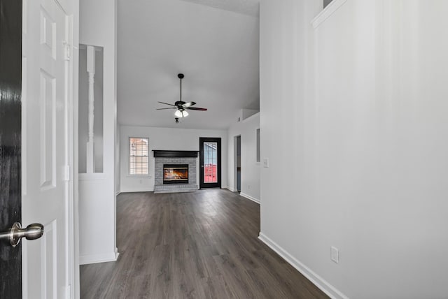 1300 Cadogan Way, Antioch, TN 37013 - unfurnished living room featuring a ceiling fan, dark wood-style flooring, a brick fireplace, and vaulted ceiling