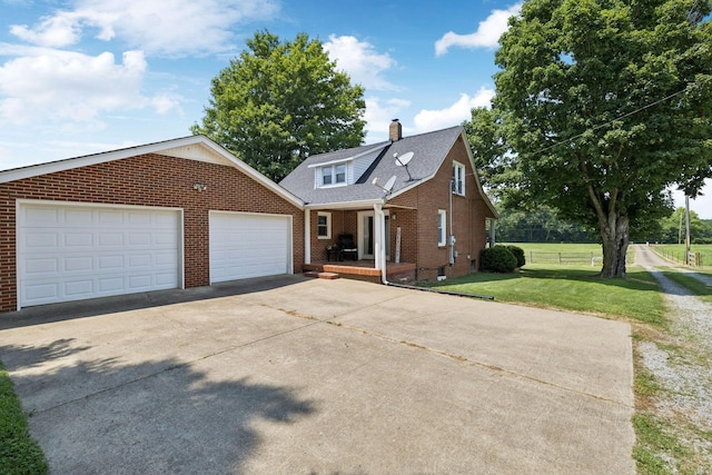 2274 Indian Mound Rd, Woodlawn, TN 37191 - view of front of house with brick siding, a porch, driveway, a front yard, and a chimney