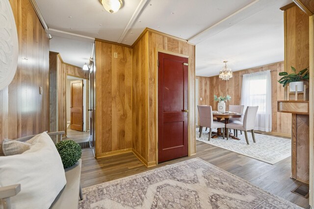 2274 Indian Mound Rd, Woodlawn, TN 37191 - entryway featuring wood walls, a chandelier, and wood finished floors