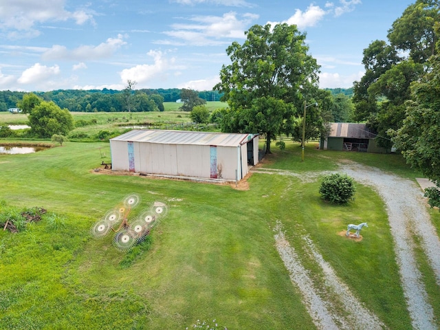 2274 Indian Mound Rd, Woodlawn, TN 37191 - view of grassy yard with a pole building, an outdoor structure, and a water view