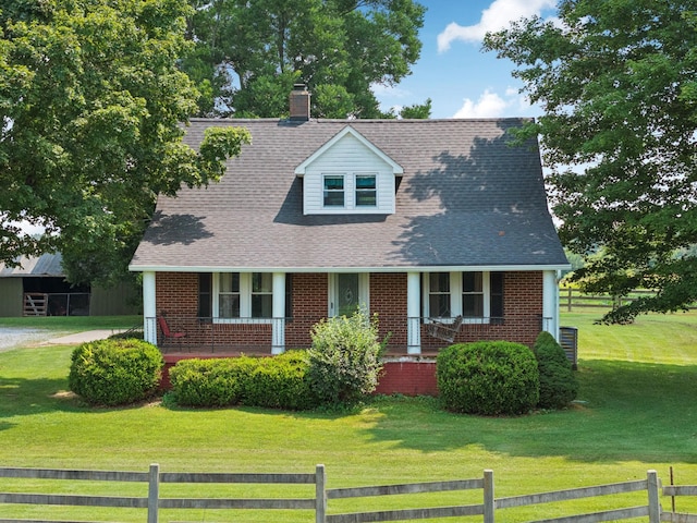 2274 Indian Mound Rd, Woodlawn, TN 37191 - cape cod house featuring covered porch, brick siding, and a shingled roof