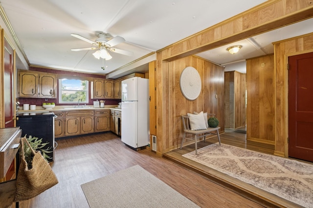 2274 Indian Mound Rd, Woodlawn, TN 37191 - kitchen with freestanding refrigerator, wooden walls, brown cabinets, ceiling fan, and light countertops