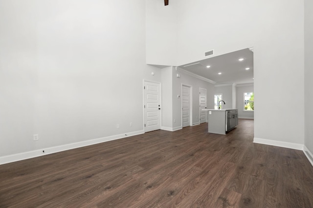 510 Rohan Dr, Murfreesboro, TN 37129 - unfurnished living room with ornamental molding, dark wood-style flooring, a high ceiling, and recessed lighting