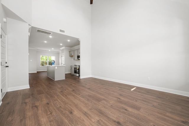 510 Rohan Dr, Murfreesboro, TN 37129 - unfurnished living room featuring ornamental molding, dark wood-type flooring, and recessed lighting