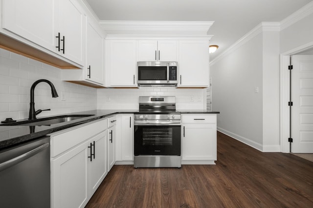 512 Rohan Dr, Murfreesboro, TN 37129 - kitchen featuring appliances with stainless steel finishes, dark wood finished floors, backsplash, white cabinets, and ornamental molding