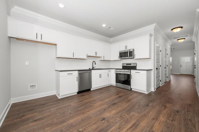 512 Rohan Dr, Murfreesboro, TN 37129 - kitchen with stainless steel appliances, dark countertops, tasteful backsplash, white cabinetry, and recessed lighting