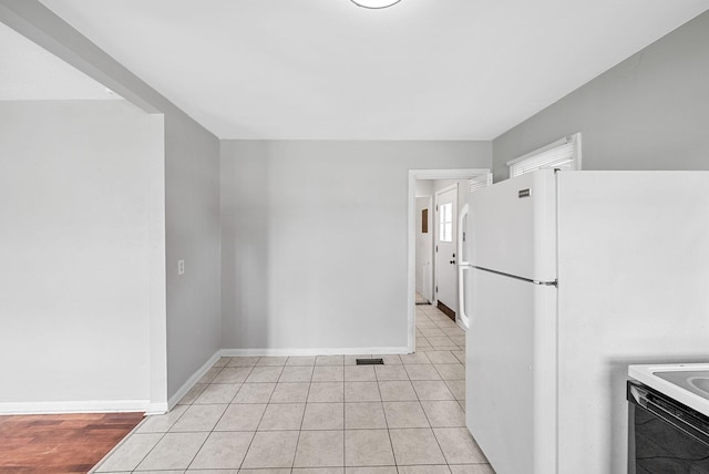 211 Navaho Trl, Hopkinsville, KY 42240 - kitchen featuring freestanding refrigerator, electric range, and light tile patterned floors
