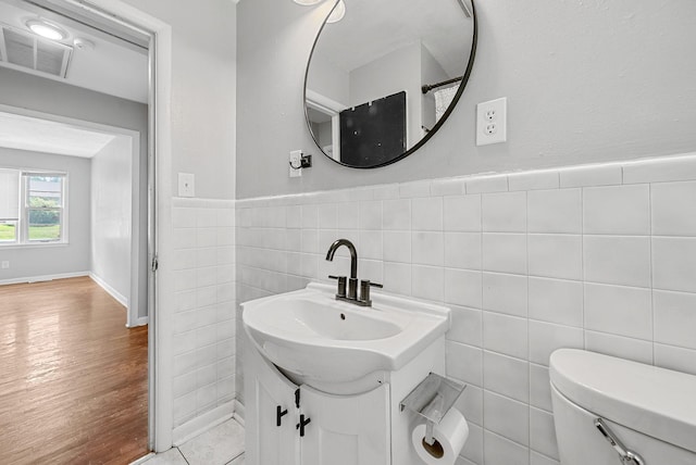 211 Navaho Trl, Hopkinsville, KY 42240 - bathroom with vanity, tile walls, a wainscoted wall, and wood finished floors