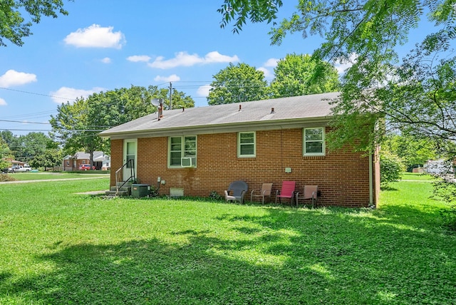 211 Navaho Trl, Hopkinsville, KY 42240 - back of property with a lawn, brick siding, and cooling unit