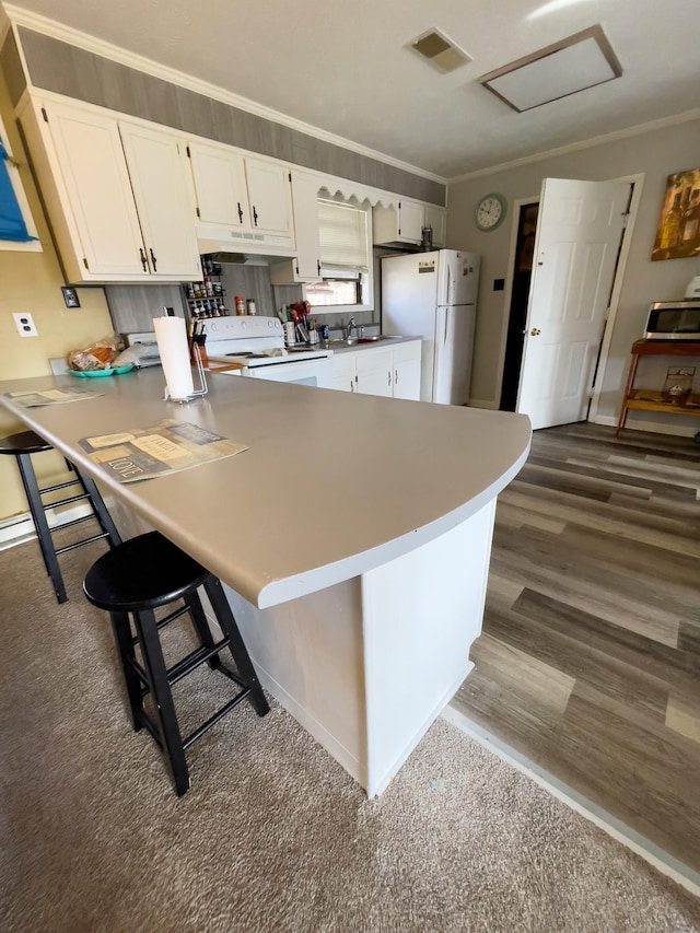 169 Wyndotte Way, Ledbetter, KY 42058 - kitchen with white appliances, crown molding, a peninsula, a kitchen breakfast bar, and white cabinetry