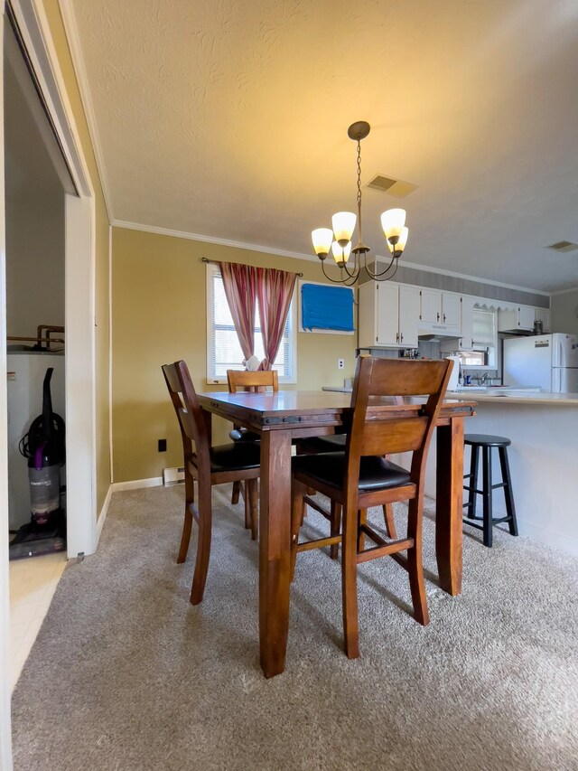169 Wyndotte Way, Ledbetter, KY 42058 - dining room featuring crown molding, light carpet, a chandelier, and a textured ceiling