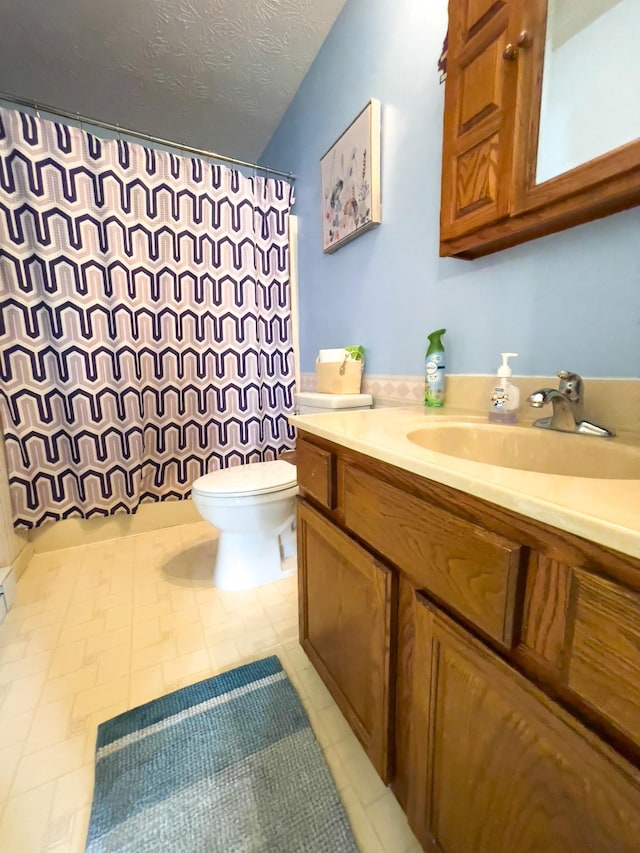 169 Wyndotte Way, Ledbetter, KY 42058 - full bathroom featuring vanity, a shower with shower curtain, a textured ceiling, and tile patterned floors