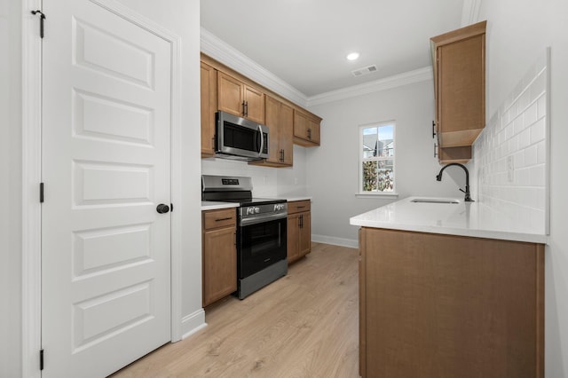 514 Rohan Dr, Murfreesboro, TN 37129 - kitchen with stainless steel appliances, light wood-style floors, crown molding, backsplash, and brown cabinets