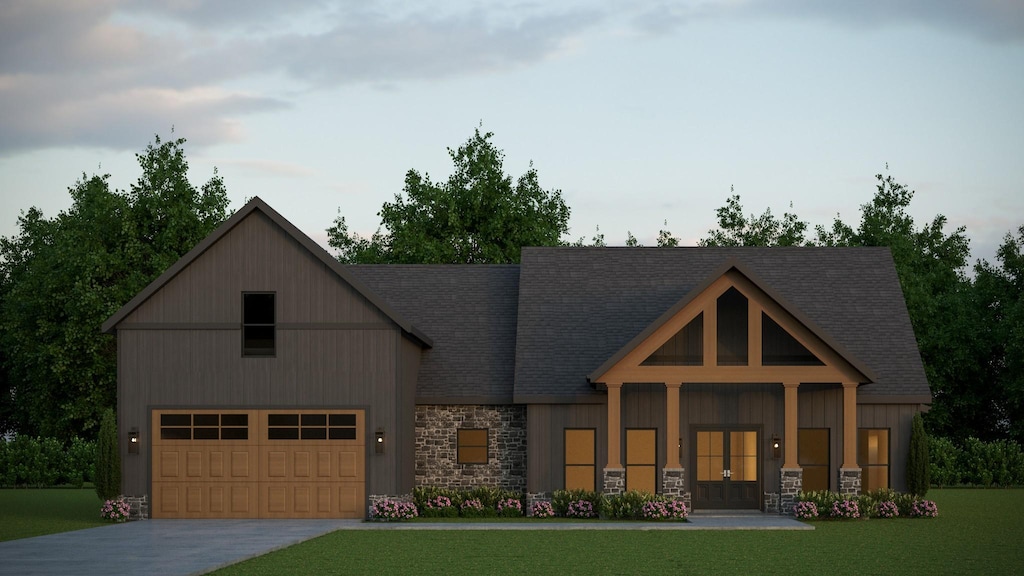 254 Bellshire Dr, Clarksville, TN 37043 - view of front of property with stone siding, driveway, a front lawn, french doors, and an attached garage