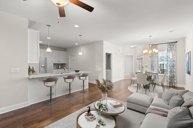 604 Douglas St, Lebanon, TN 37087 - living room with dark wood-style floors, recessed lighting, ceiling fan, and a chandelier
