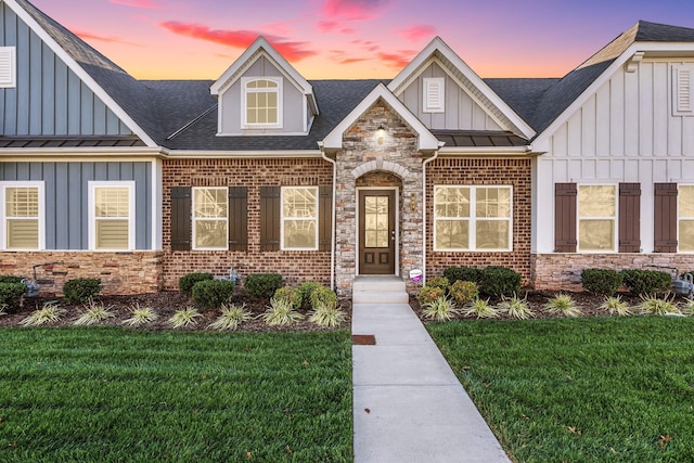 604 Douglas St, Lebanon, TN 37087 - view of front facade with board and batten siding, a yard, roof with shingles, and stone siding