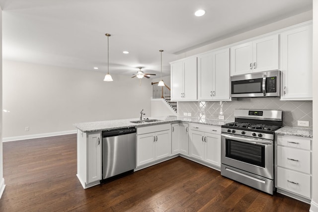 604 Douglas St, Lebanon, TN 37087 - kitchen featuring stainless steel appliances, dark wood finished floors, recessed lighting, a peninsula, and decorative backsplash