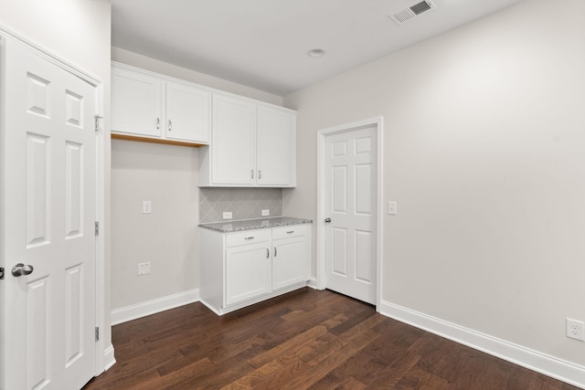 604 Douglas St, Lebanon, TN 37087 - kitchen featuring dark wood-style floors, white cabinets, tasteful backsplash, and light stone counters