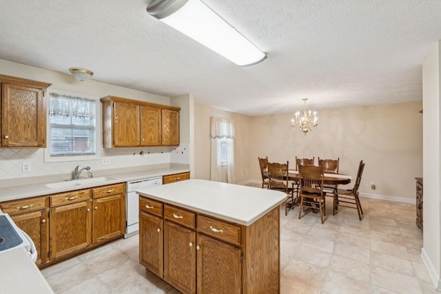 1011 Shirley Dr, Lebanon, TN 37087 - kitchen featuring white dishwasher, brown cabinets, light countertops, and a textured ceiling