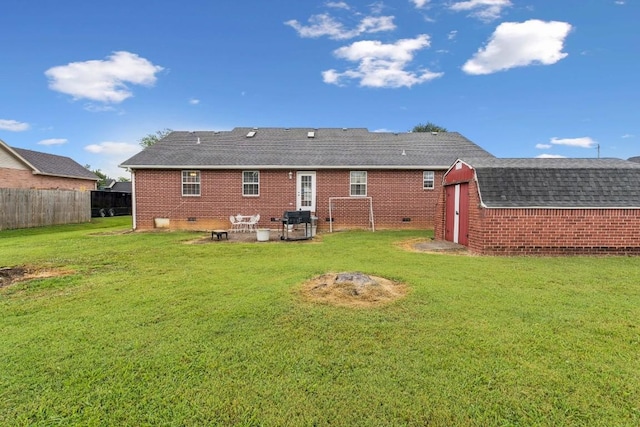 1011 Shirley Dr, Lebanon, TN 37087 - rear view of property featuring a storage unit, brick siding, roof with shingles, and crawl space