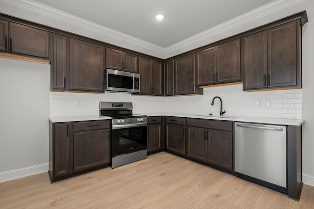 516 Rohan Dr, Murfreesboro, TN 37129 - kitchen with stainless steel appliances, light wood-style flooring, dark brown cabinetry, light countertops, and decorative backsplash