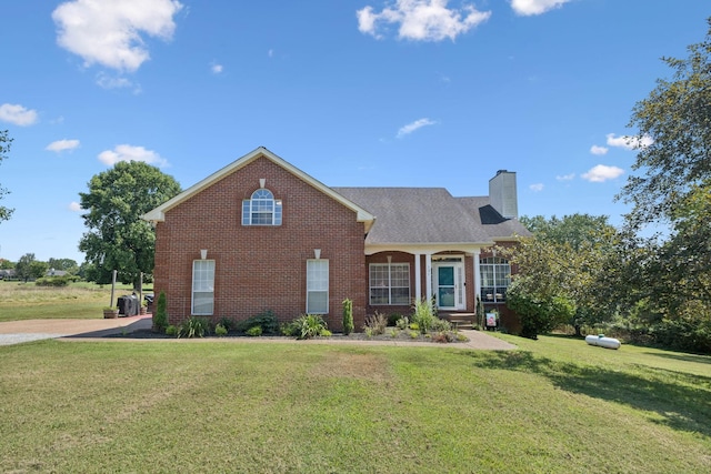 131 E Robertson Rd, Castalian Springs, TN 37031 - traditional home with brick siding, a chimney, and a front lawn