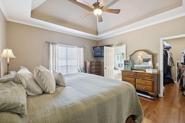 131 E Robertson Rd, Castalian Springs, TN 37031 - bedroom with a tray ceiling, a walk in closet, dark wood-type flooring, ornamental molding, and ceiling fan