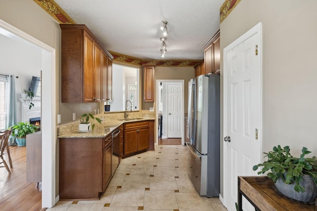 131 E Robertson Rd, Castalian Springs, TN 37031 - kitchen with appliances with stainless steel finishes, brown cabinets, and light stone counters